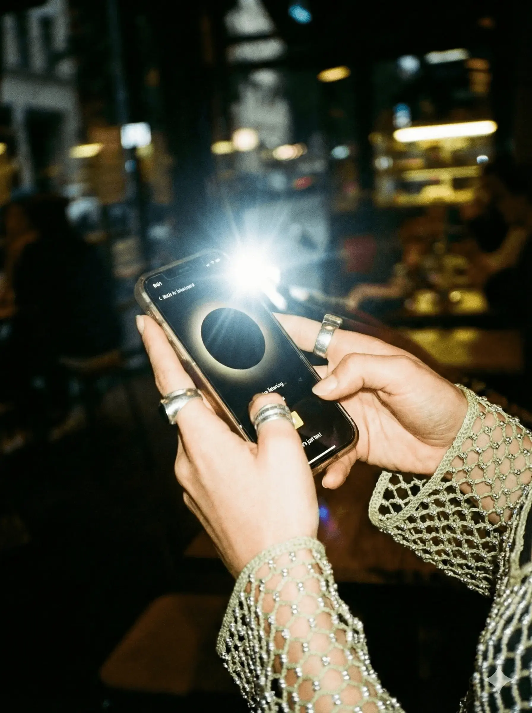 Woman on a night out checking her phone, mid-thought
